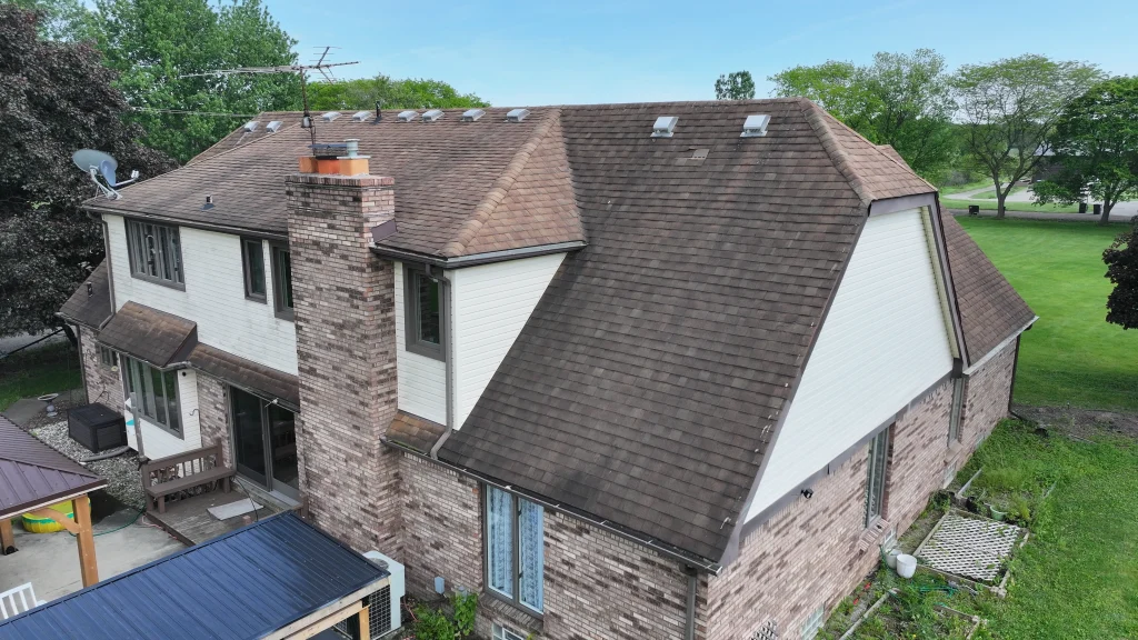 Aerial view of an aging asphalt shingle roof before roof replacement